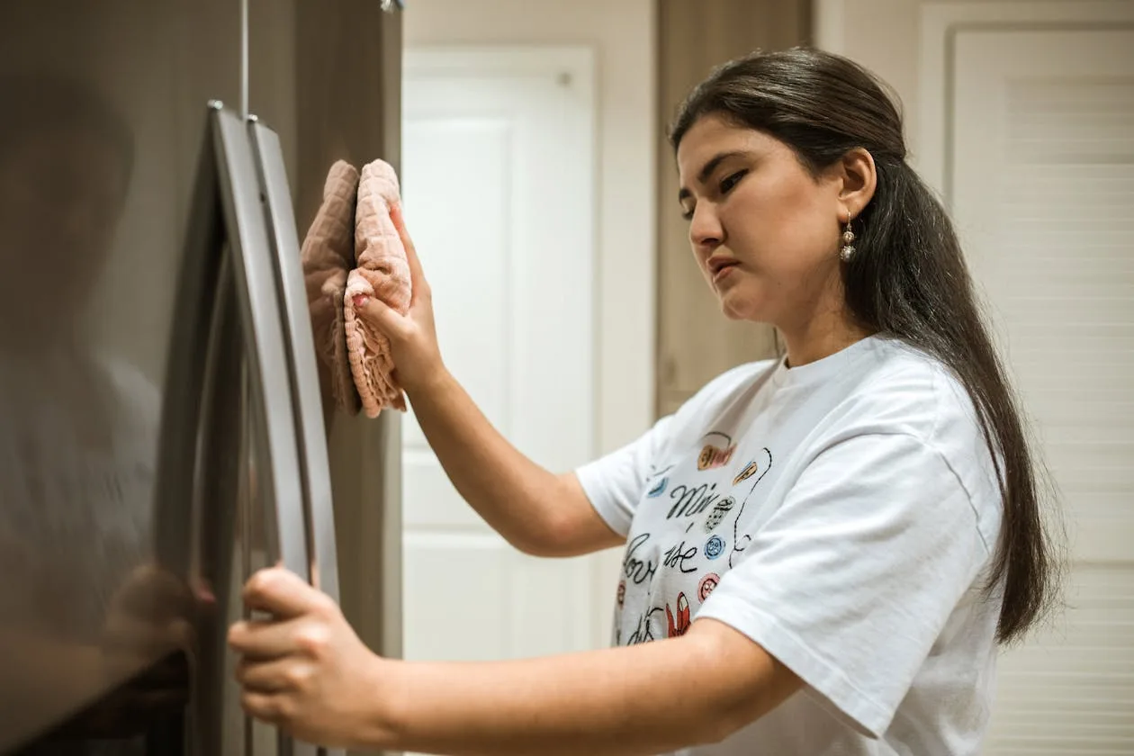 Phoenix appliance repair pro inspecting a residential refrigerator after being matched with the homeowner through the exclusive appliance repair leads system.